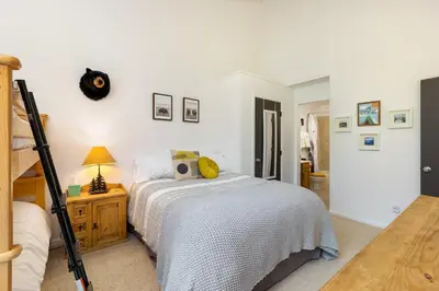 a white bedroom with a bed and a ladder at Mountain view, kids room, great location! in Silverthorne