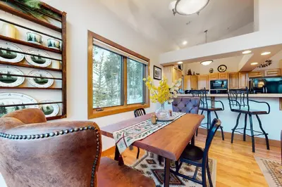 a kitchen and dining room with a table and chairs at Elk Trail Retreat in Winter Park