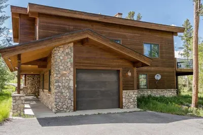 a house with a garage in front of it at Elk Trail Retreat in Winter Park