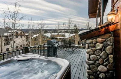 a hot tub on the deck of a house at Elk Trail Retreat in Winter Park