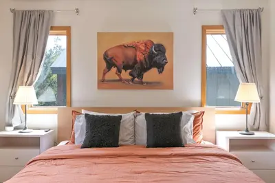 a bedroom with a bed and two windows at Windwood Alpine Townhome: Downtown Frisco in Frisco