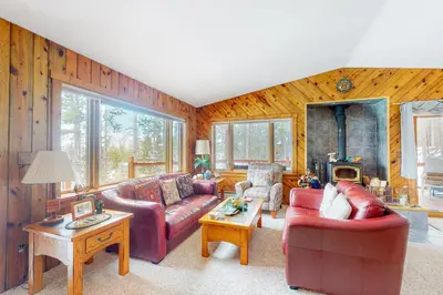 a living room with two couches and a fireplace at Wapiti Point - Main House in Grand Lake