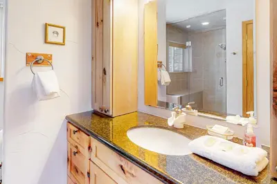 a bathroom with a sink and a mirror at Wapiti Point - Main House in Grand Lake
