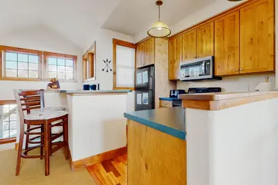 a kitchen with wooden cabinets and a counter top at Majestic Mountain Escape in Granby