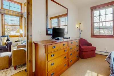 a bedroom with a dresser with a television on it at Majestic Mountain Escape in Granby