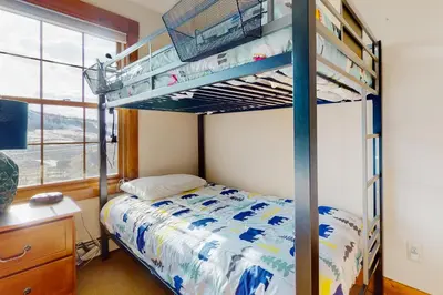 a bedroom with a bunk bed and a desk at Majestic Mountain Escape in Granby
