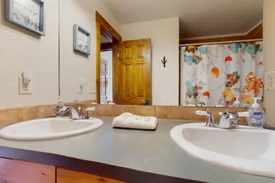 a bathroom with two sinks and a large mirror at Majestic Mountain Escape in Granby