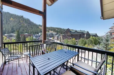 a table and chairs on a balcony with a view at Premium Unit 4575-Fraser Crossing Founders Pointe condo in Winter Park