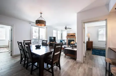 a dining room and living room with a table and chairs at Premium Unit 4575-Fraser Crossing Founders Pointe condo in Winter Park