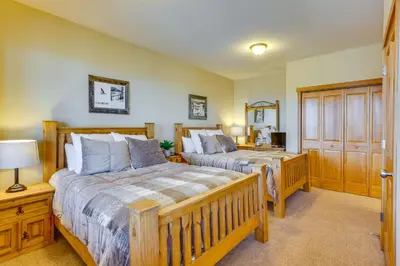 a bedroom with two beds and a wooden door at Private Hot Tub Scenic Granby Vacation Rental! in Granby