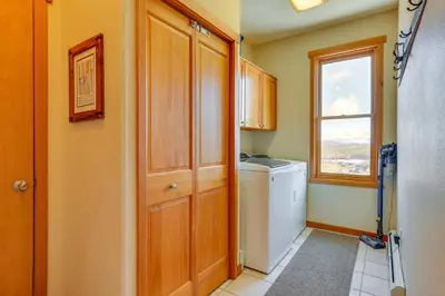 a laundry room with a washer and dryer and a window at Private Hot Tub Scenic Granby Vacation Rental! in Granby