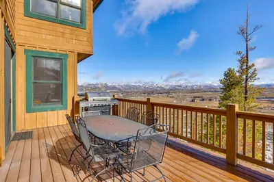 a patio with a table and chairs on a deck at Private Hot Tub Scenic Granby Vacation Rental! in Granby
