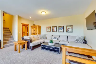 a living room with a couch and a table at Private Hot Tub Scenic Granby Vacation Rental! in Granby