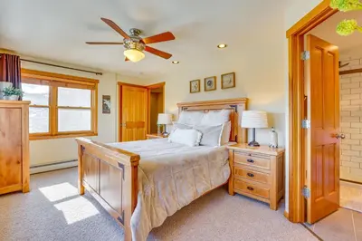 a bedroom with a bed and a ceiling fan at Private Hot Tub Scenic Granby Vacation Rental! in Granby