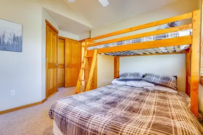 a bedroom with two bunk beds in a house at Private Hot Tub Scenic Granby Vacation Rental! in Granby