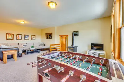 a living room with a pool table in the middle of it at Private Hot Tub Scenic Granby Vacation Rental! in Granby